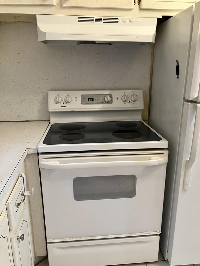 226 Camden J, West Palm Beach, FL 33417 - kitchen view of white appliances, extractor fan, light countertops, and white cabinets