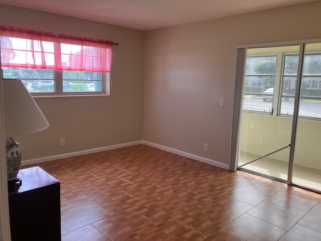 unfurnished room with wood-type flooring and a wealth of natural light