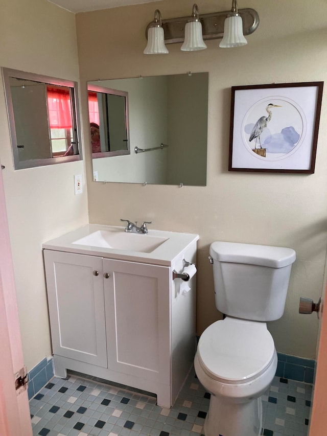 bathroom featuring toilet, vanity, and tile patterned floors