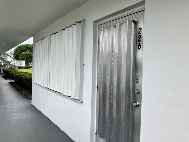 226 Camden J, West Palm Beach, FL 33417 - view of exterior entry featuring stucco siding