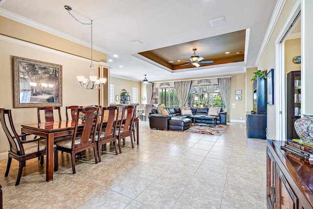 dining room with ceiling fan with notable chandelier, a raised ceiling, light tile floors, and ornamental molding