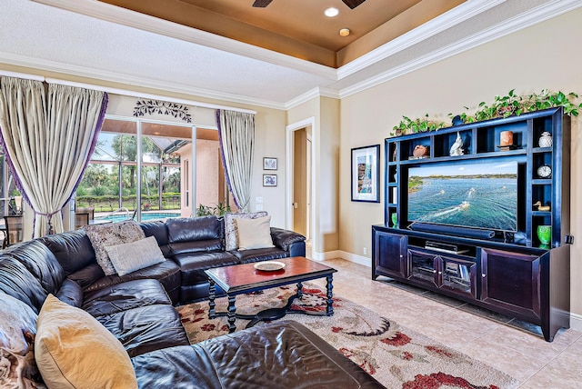 tiled living room with a tray ceiling and ornamental molding