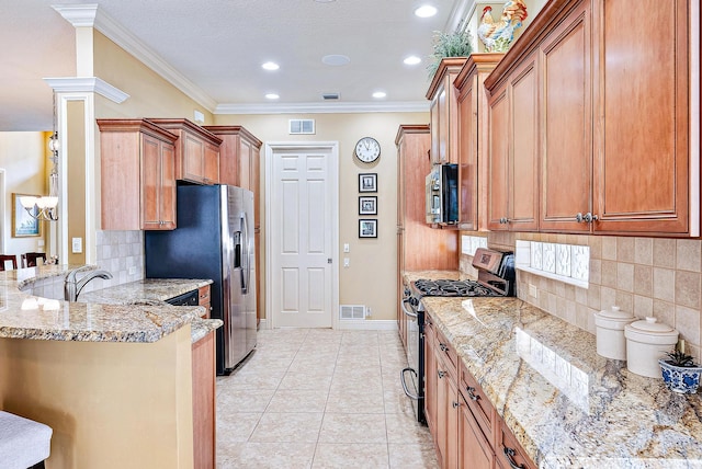 kitchen featuring light stone counters, light tile flooring, tasteful backsplash, stainless steel appliances, and a kitchen breakfast bar