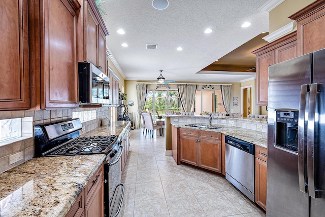 kitchen with ceiling fan, light tile flooring, tasteful backsplash, stainless steel appliances, and ornamental molding