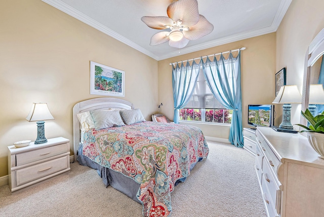 carpeted bedroom with ornamental molding and ceiling fan