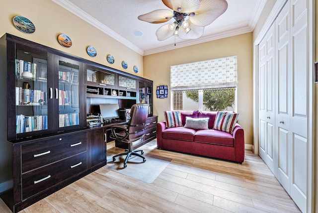 home office featuring ornamental molding, light hardwood / wood-style flooring, ceiling fan, and a textured ceiling