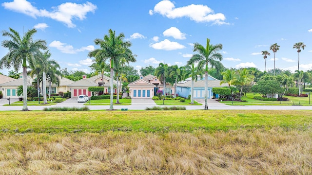 single story home featuring a front yard and a garage