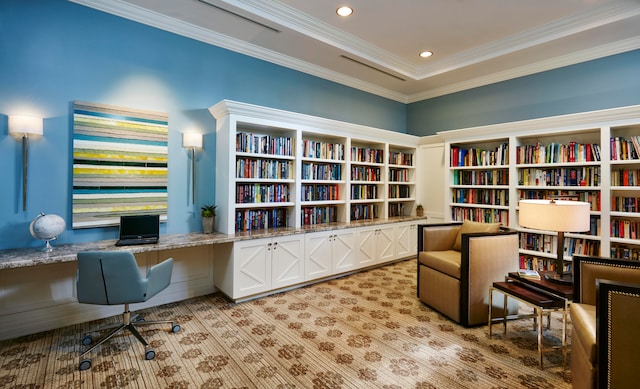 office area with light colored carpet and built in desk