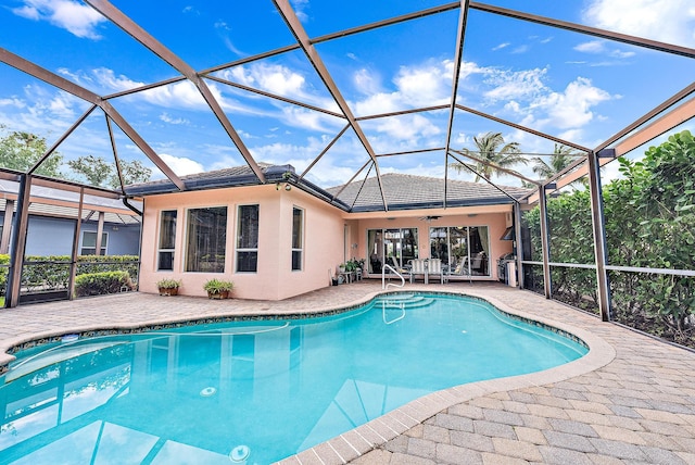 view of swimming pool with a patio area and glass enclosure