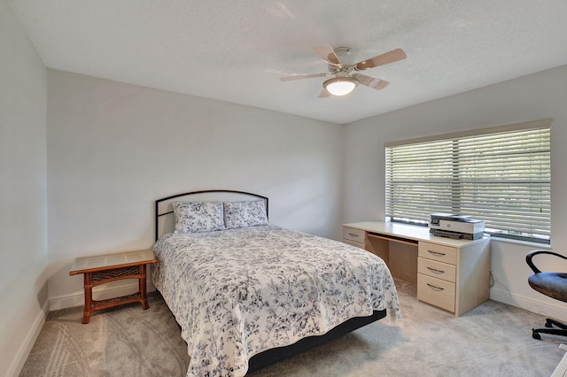 carpeted bedroom featuring a textured ceiling and ceiling fan