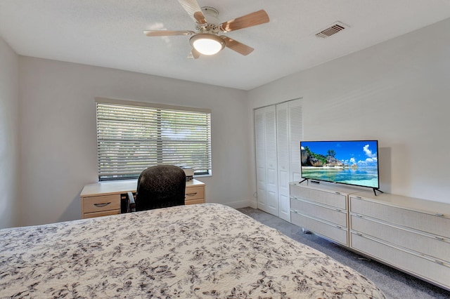 carpeted bedroom with a closet and ceiling fan