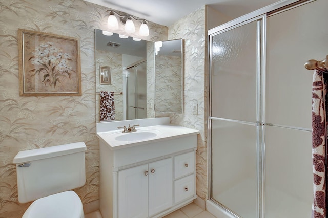 bathroom with tile floors, a shower with shower door, toilet, and large vanity