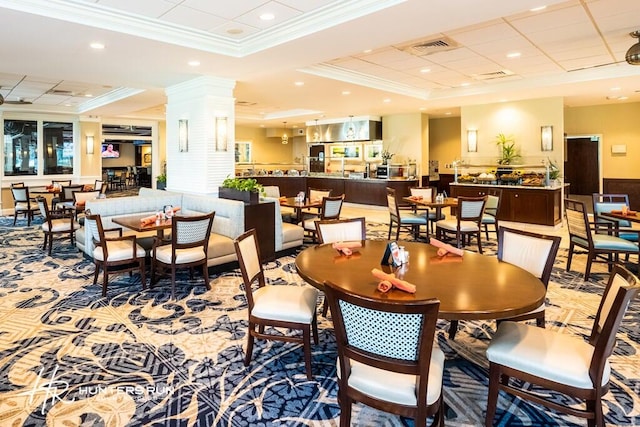 dining area with ornamental molding, carpet floors, and a tray ceiling