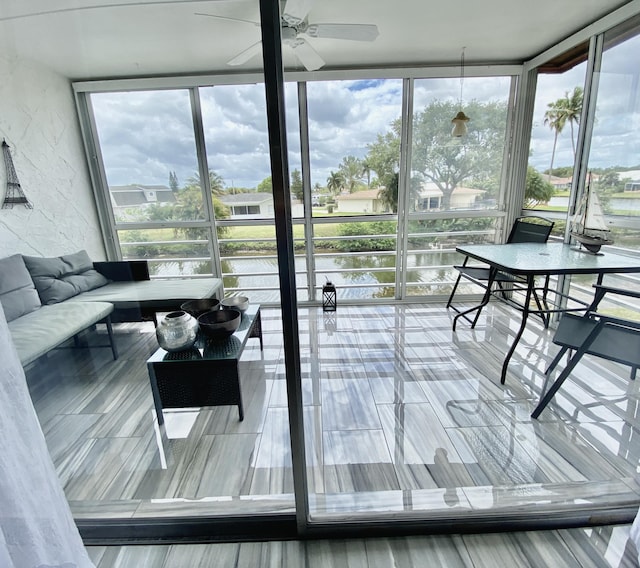 sunroom with a wealth of natural light and a ceiling fan