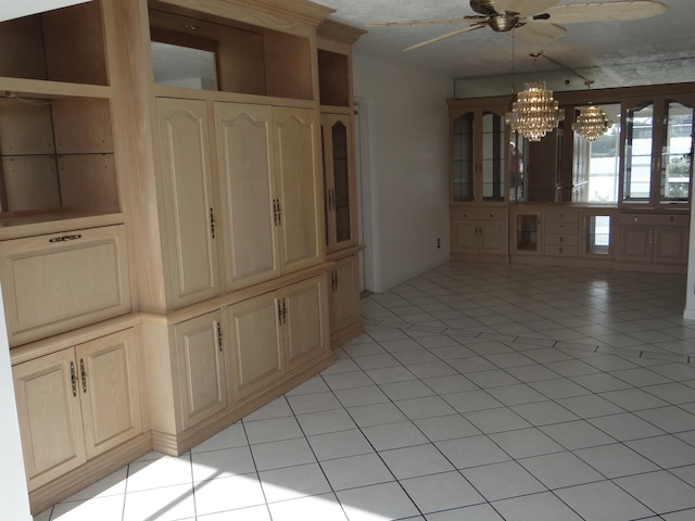 unfurnished dining area featuring ceiling fan with notable chandelier and light tile patterned floors