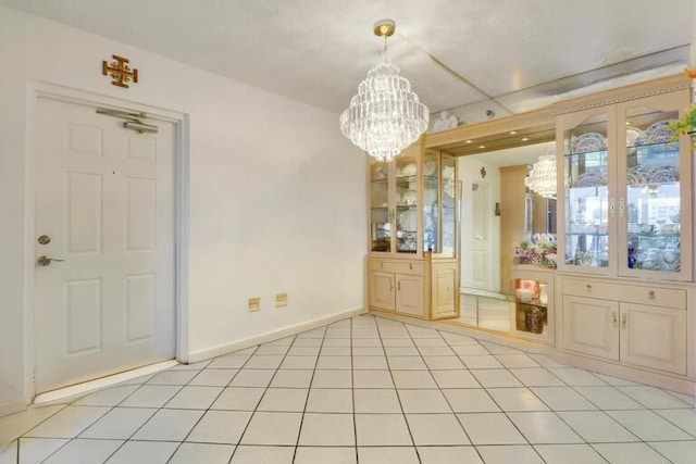 unfurnished dining area with light tile patterned floors and a chandelier