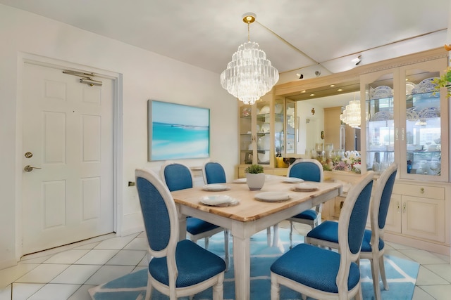 tiled dining space featuring an inviting chandelier