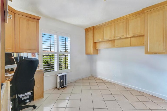 unfurnished office featuring light tile patterned floors