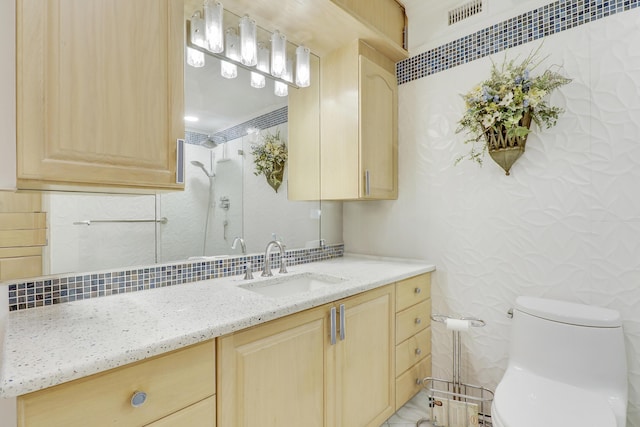 bathroom with toilet, backsplash, and vanity