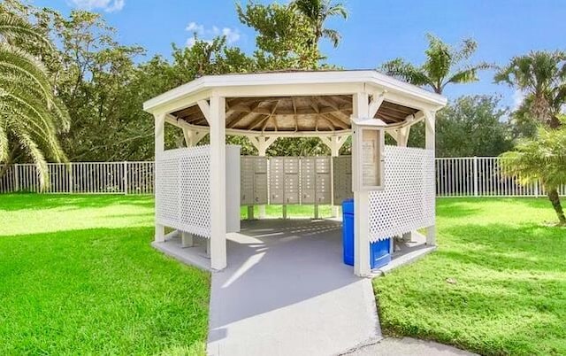 surrounding community featuring a lawn, a gazebo, and mail boxes