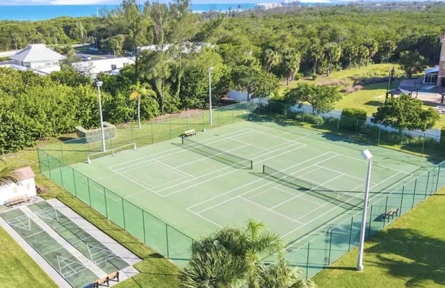 view of sport court featuring a lawn