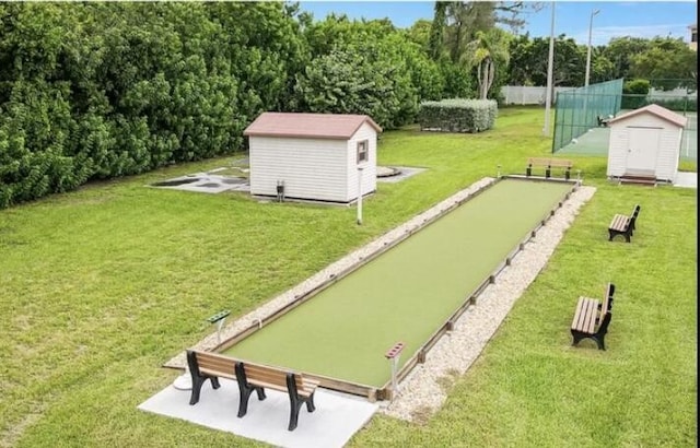 surrounding community featuring a lawn and a storage shed