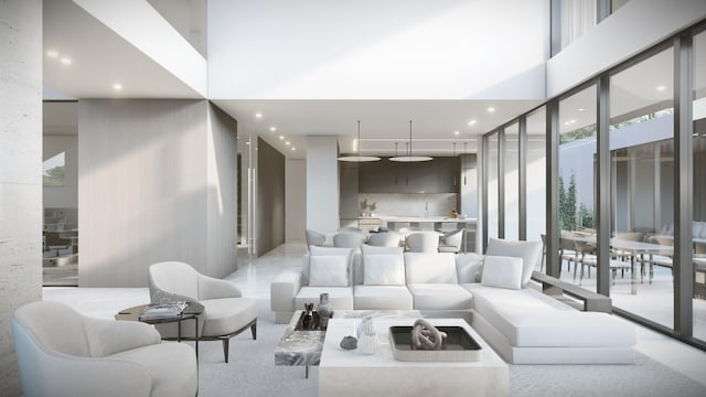 sunken living room featuring a towering ceiling, a wall of windows, and recessed lighting