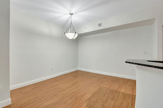 unfurnished room featuring light wood-type flooring