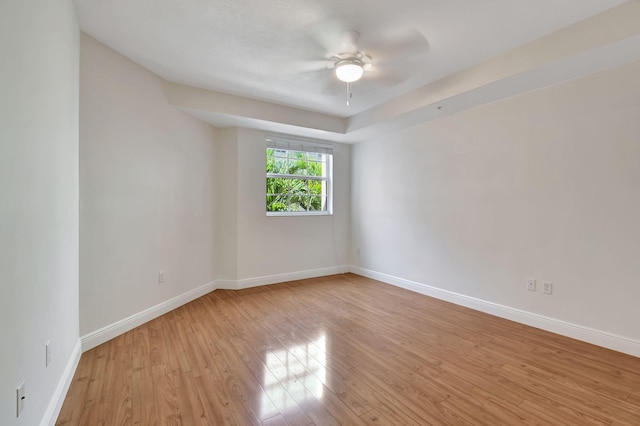 empty room with ceiling fan and light wood-type flooring