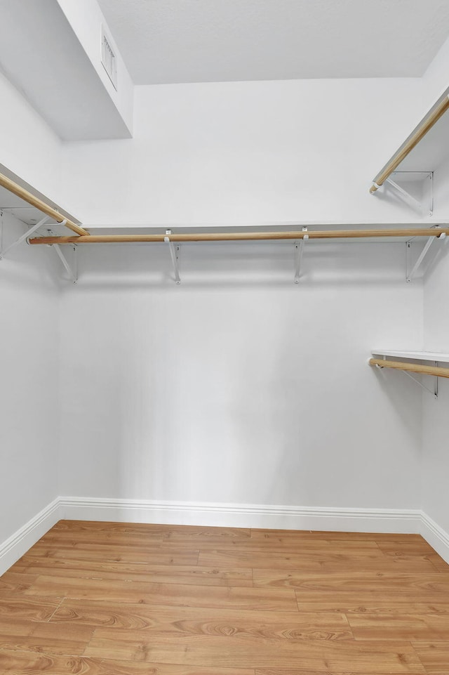 spacious closet with light hardwood / wood-style floors