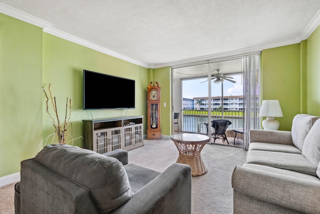 living room with ornamental molding, carpet flooring, ceiling fan, and a textured ceiling