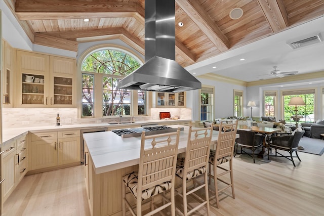 kitchen with island exhaust hood, lofted ceiling with beams, wood ceiling, and light hardwood / wood-style floors