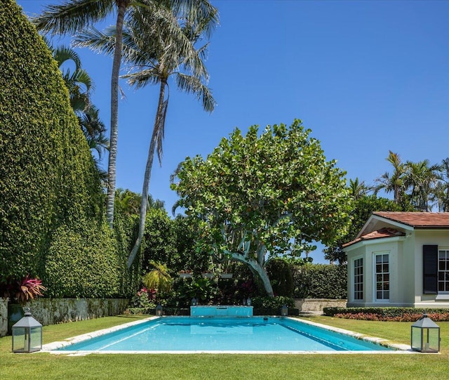 view of swimming pool featuring a yard