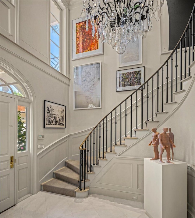 tiled foyer entrance with a notable chandelier