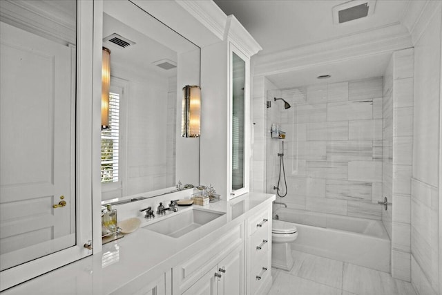 full bathroom with tiled shower / bath combo, toilet, crown molding, and vanity