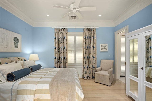 bedroom with ceiling fan, light wood-type flooring, crown molding, and french doors