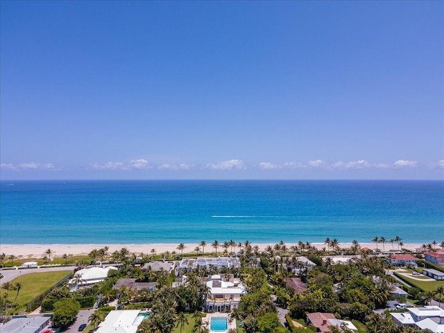 drone / aerial view with a water view and a beach view