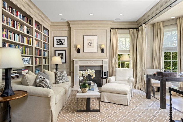 sitting room with crown molding and a wealth of natural light