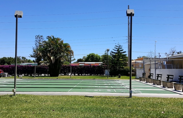 view of property's community with a lawn