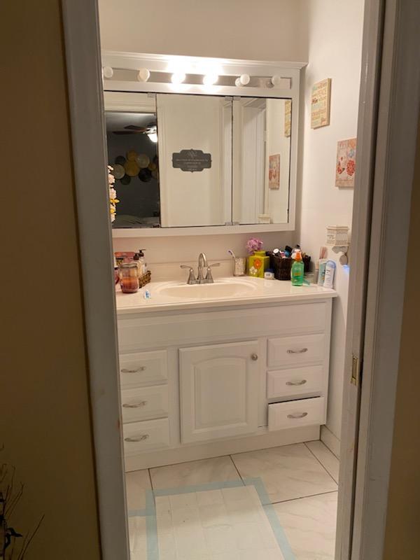 bathroom with ceiling fan, tile floors, and vanity