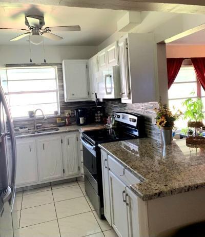 kitchen with tasteful backsplash, ceiling fan, stainless steel appliances, and white cabinetry