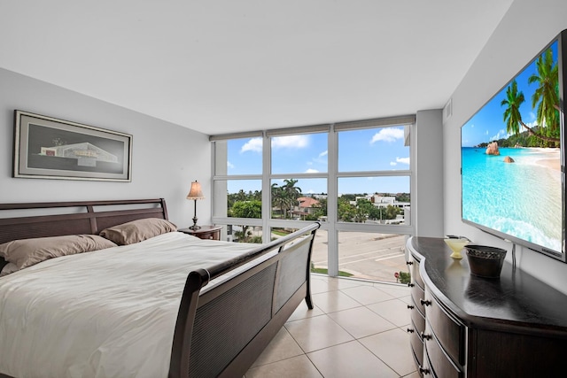 tiled bedroom with floor to ceiling windows