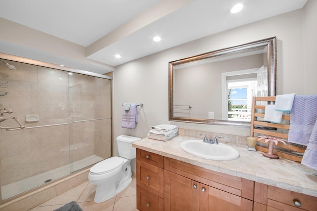 bathroom featuring toilet, tile patterned floors, vanity, and an enclosed shower