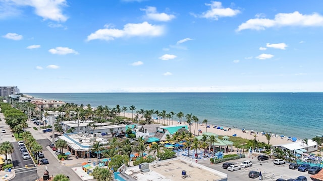 drone / aerial view featuring a water view and a view of the beach