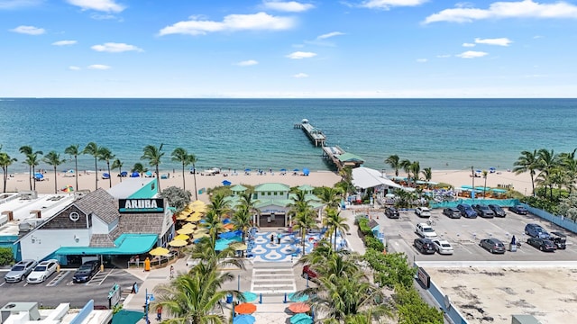 birds eye view of property featuring a water view and a beach view