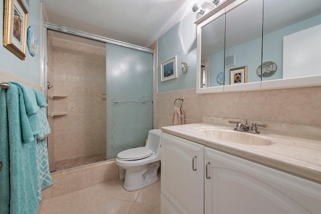 bathroom featuring vanity with extensive cabinet space, toilet, tile floors, and tile walls