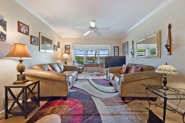 living room featuring ceiling fan, crown molding, and hardwood / wood-style flooring