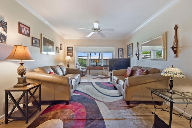 living room with hardwood / wood-style floors, crown molding, and ceiling fan