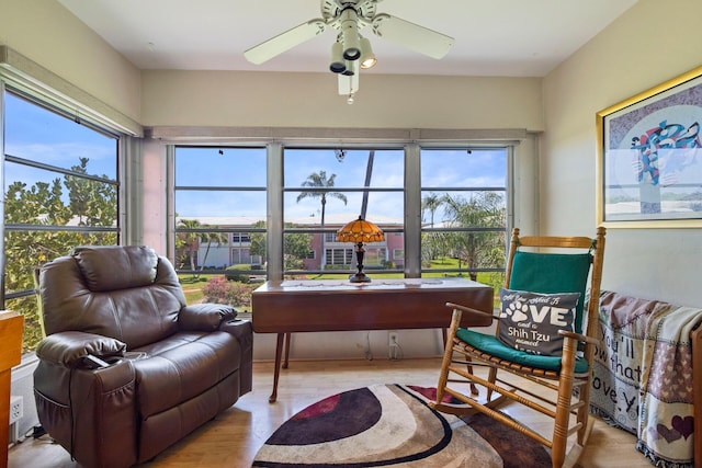 sunroom featuring ceiling fan