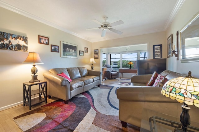 living room featuring hardwood / wood-style flooring, ceiling fan, a healthy amount of sunlight, and crown molding